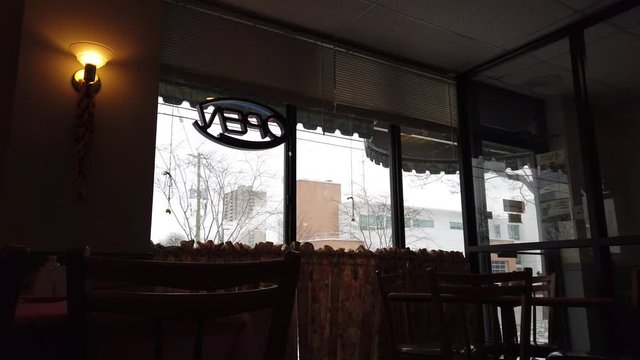 Window Diner Restaurant Open Sign On Window With Chairs Andsmoke Cloud Blowing In Front Of Buildings