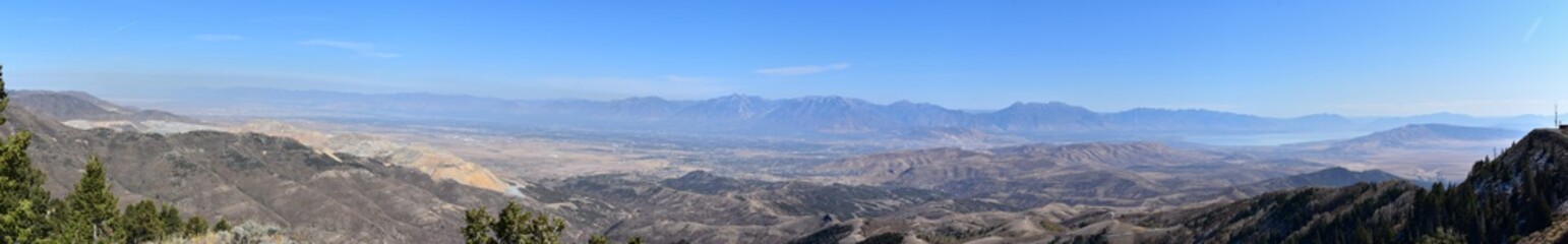 Rocky Mountain Wasatch Front peaks, panorama landscape view from Butterfield canyon Oquirrh range by Rio Tinto Bingham Copper Mine, Great Salt Lake Valley in fall. Utah, United States.