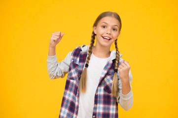 Change for the better. school girl casual style. autumn kid fashion. child cute blond hair. childhood happiness. happy childrens day. small girl checkered jacket. hipster girl yellow wall