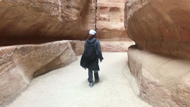 woman walking by sik gorge in petra city jordan beauty, natural jordan, travel concept