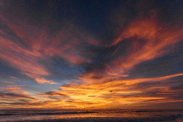 Naklejka na ściany i meble Beautiful sunset on the ocean. Color of the sky