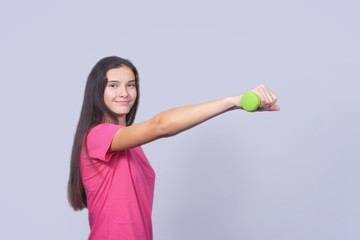 Fitness sport girl smiling happy. Fitness woman lifting dumbbells strength training biceps doing curls. Mixed Caucasian and Asian fitness model portrait isolated on white background.