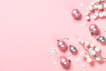 Christmas flat lay background on pink with decorations.