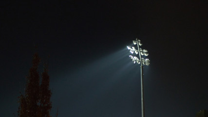 rugby stadium lights during game over dark blue sky in england uk