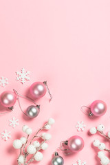 Christmas flat lay background on pink with decorations.