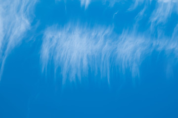 High white clouds in bright blue sky