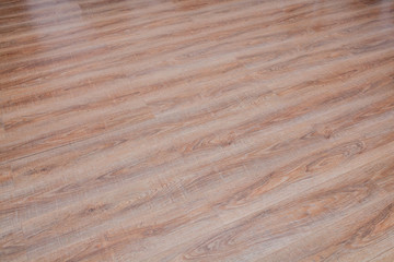 The floor of the light brown laminate diagonally