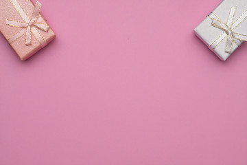 Romantic concept for Valentine`s Day. Flat lay. peach color and white gift box on a pink background .  Copy Space.