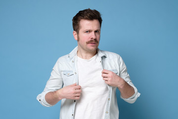 Expressive caucasian man with retro mustache frowning being anxious.