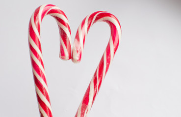 Fototapeta premium Christmas candy on a white background in the form of a heart, with free space for writing