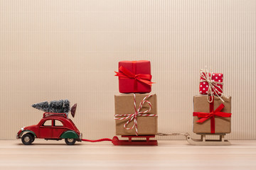 christmas red toy car with sledges gift fir-tree