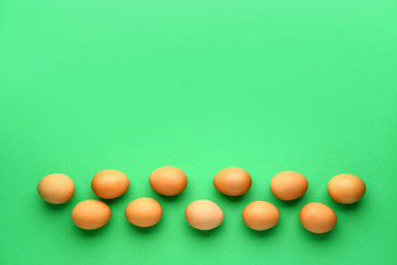 Fresh eggs on color background