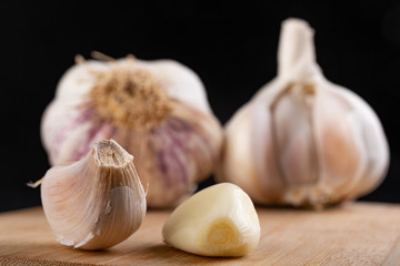 Fresh garlic on a kitchen chopping board. Healthy vegetables on a table in a home kitchen.
