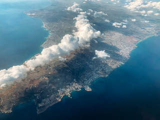 Aerial view of Cyprus island and blue Mediterranean sea from airplane window.