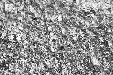Crumpled silver foil as background, closeup view