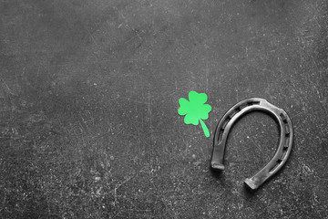 Horseshoe with clover on dark background. St. Patrick's Day celebration