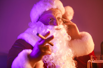 Funny drunk Santa Claus with cigar in pub
