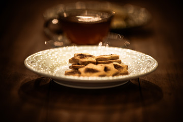 Tea cups with thin cream wafers. Teas with hot smoke. Fine cookies with accompanying special teas.