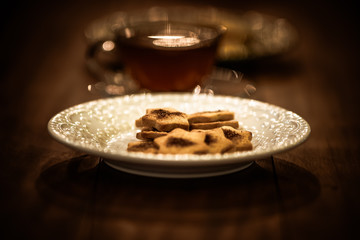 Tea cups with thin cream wafers. Teas with hot smoke. Fine cookies with accompanying special teas.