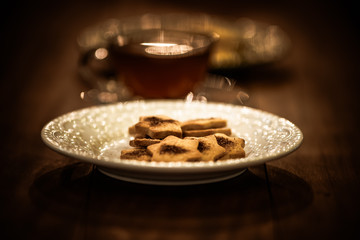 Tea cups with thin cream wafers. Teas with hot smoke. Fine cookies with accompanying special teas.