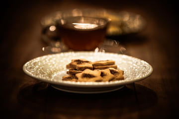 Tea cups with thin cream wafers. Teas with hot smoke. Fine cookies with accompanying special teas.