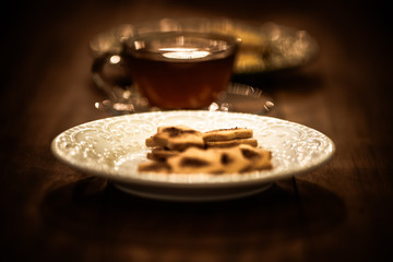 Tea cups with thin cream wafers. Teas with hot smoke. Fine cookies with accompanying special teas.