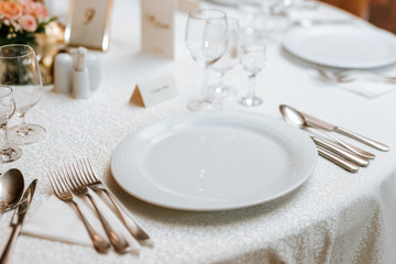 Decoration of a wedding, white flowers, candles and glasses for drinks