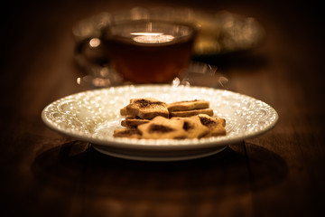 Tea cups with thin cream wafers. Teas with hot smoke. Fine cookies with accompanying special teas.