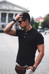  Guy in black polo and sunglasses.Business portrait.