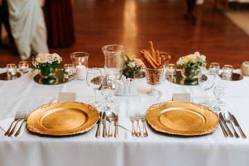 Decoration of a wedding, white flowers, candles and glasses for drinks