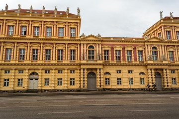 Fototapeta na wymiar View of historical building in Potsdam, Germany with two cyclists