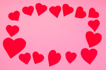 Valentines Day concept mockup. Decorative red hearts frame on pink background. Copy space.