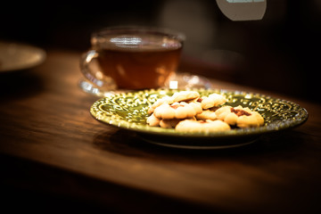 Tea cups with thin cream wafers. Teas with hot smoke. Fine cookies with accompanying special teas.