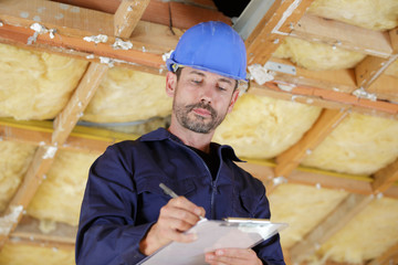 foreman making notes in renovation property