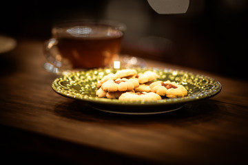 Tea cups with thin cream wafers. Teas with hot smoke. Fine cookies with accompanying special teas.