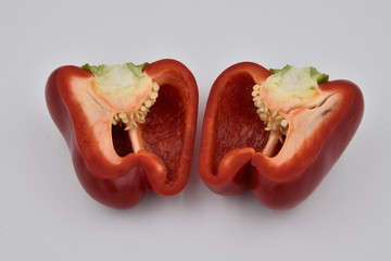 red pepper cut in half on a white background