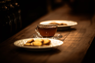 Tea cups with thin cream wafers. Teas with hot smoke. Fine cookies with accompanying special teas.