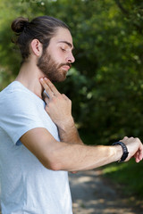 urban runner man looking app on sportwatch