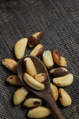 Brazilian nuts in a bowl on a wooden table. Kitchen background.