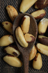 Brazilian nuts in a bowl on a wooden table. Kitchen background.