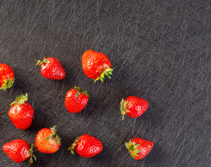Fresh strawberries lying on a black background - 309851102