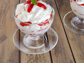 Glass bowl of strawberries with whipped cream - 309851148