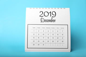 Paper calendar on light blue background. Planning concept