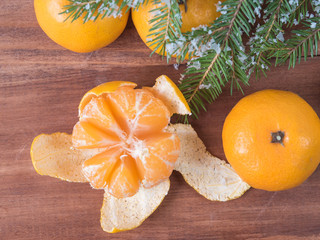 Tangerines on a wood background with Christmas tree - 309851341