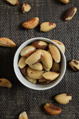 Brazilian nuts in a bowl on a wooden table. Kitchen background.