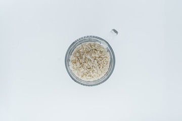 Rice in a glass mug on a white background