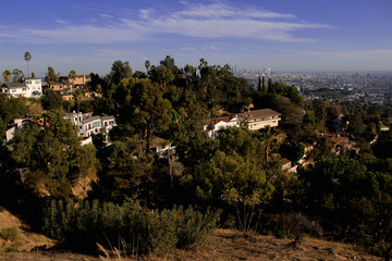 A view of downtown Los Angeles through a residential area of ​​Los Feliz off the mountain at...