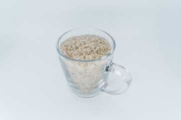 Rice in a glass mug on a white background