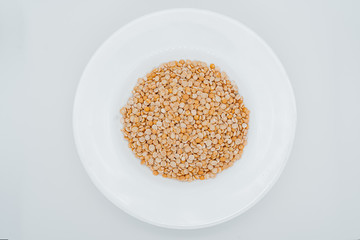 Peas on a plate white background close-up