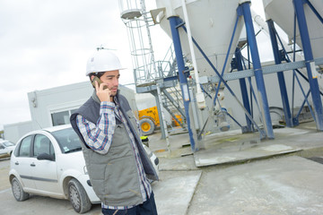 Fototapeta premium worker with hardhat talking to his cellular phone